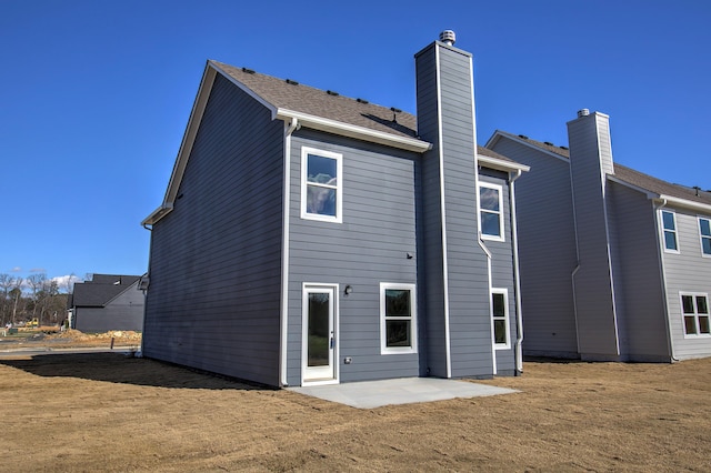 back of property with a patio