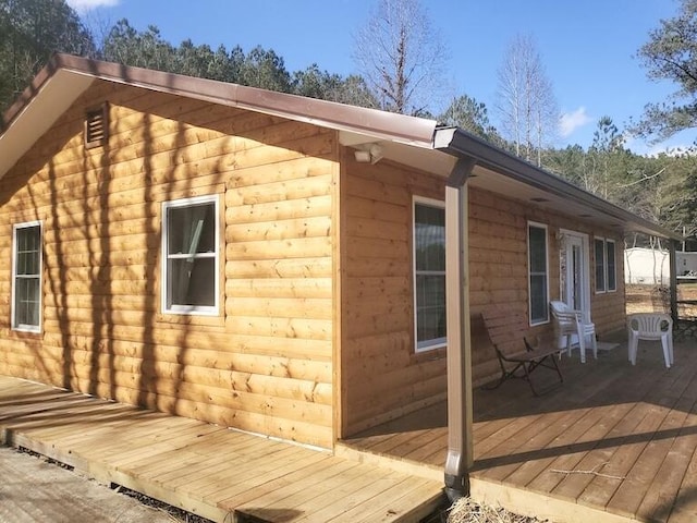 view of property exterior with a wooden deck