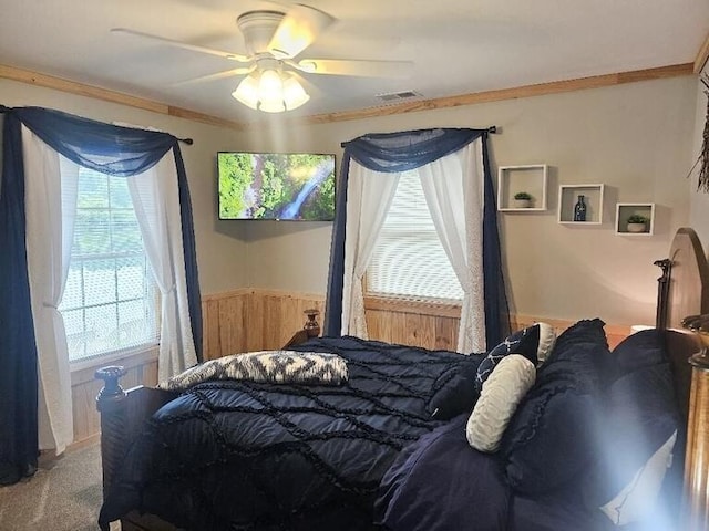 bedroom featuring multiple windows, ceiling fan, and crown molding