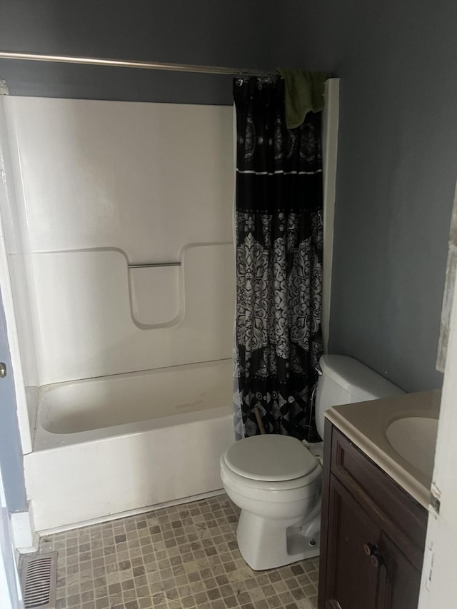 full bathroom featuring vanity, shower / bath combination with curtain, and toilet