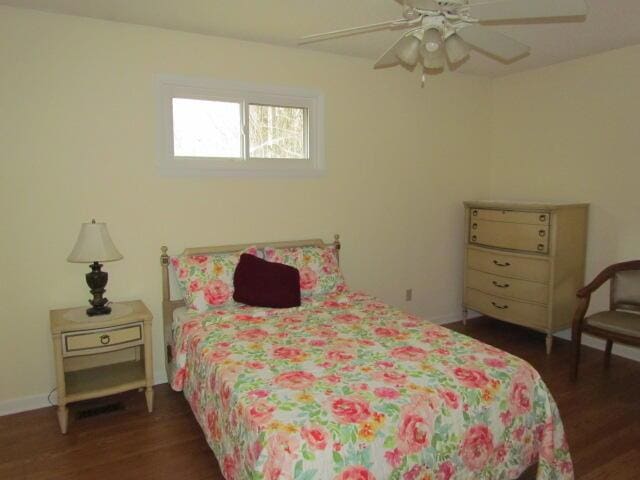 bedroom with ceiling fan and dark hardwood / wood-style floors