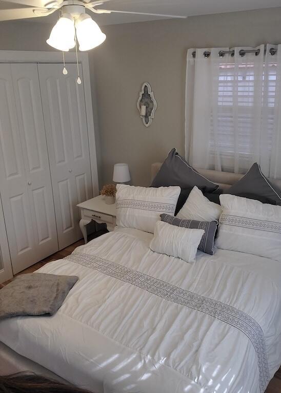 bedroom featuring ceiling fan and a closet