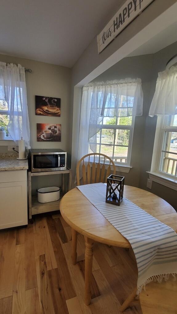 dining space with light hardwood / wood-style flooring