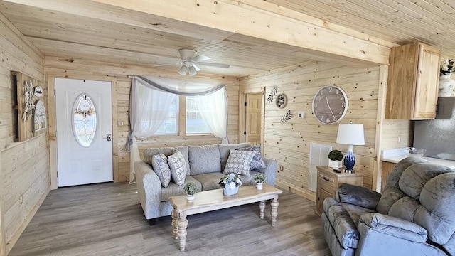 living room with wood walls, hardwood / wood-style floors, ceiling fan, and wood ceiling