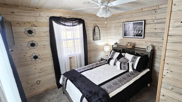 bedroom with carpet flooring, wooden walls, ceiling fan, and wooden ceiling