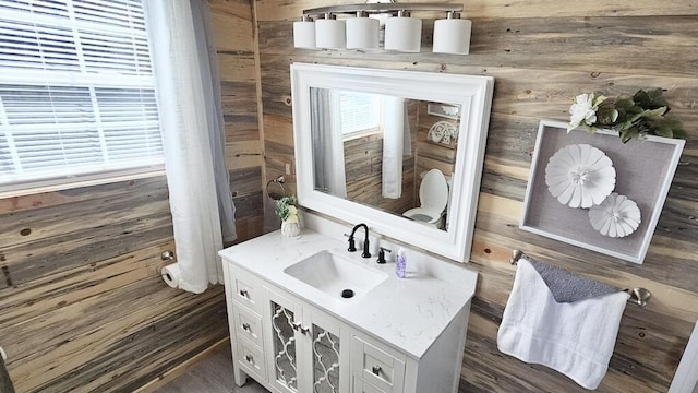 bathroom with vanity and wood walls