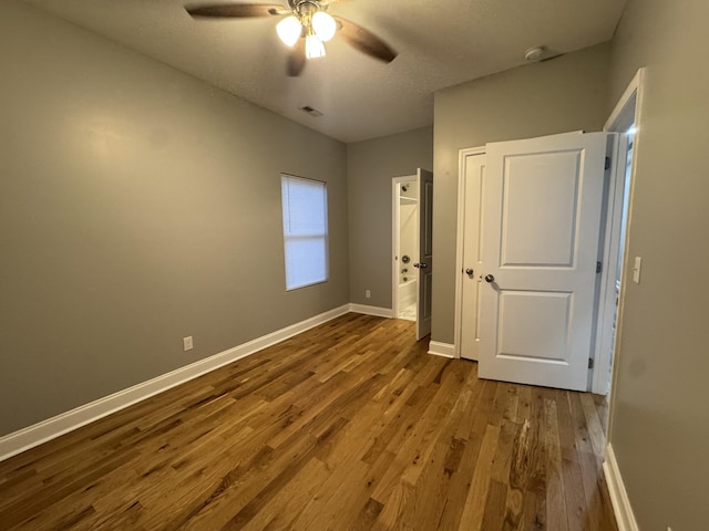 unfurnished bedroom with hardwood / wood-style flooring and ceiling fan