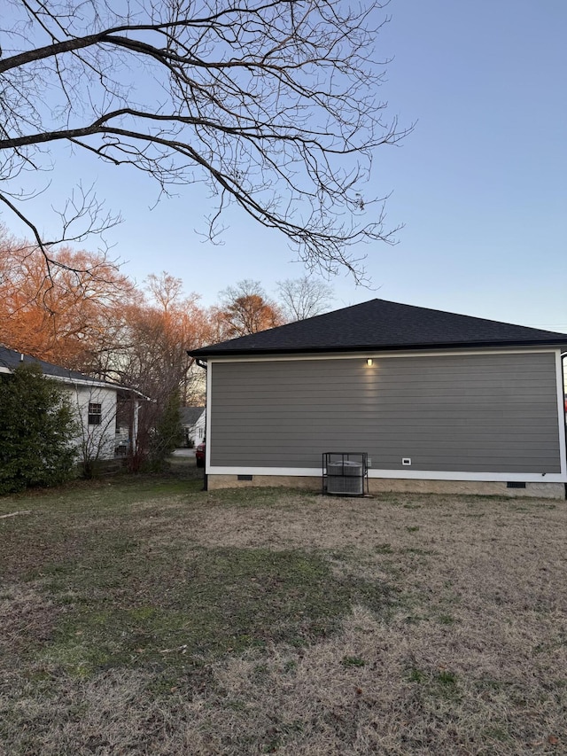 view of side of home featuring a yard