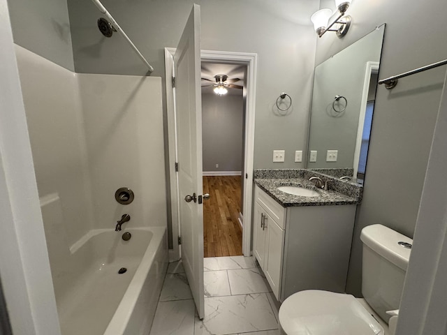 full bathroom with shower / bathing tub combination, ceiling fan, vanity, and toilet