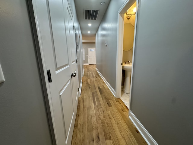 corridor with light hardwood / wood-style flooring