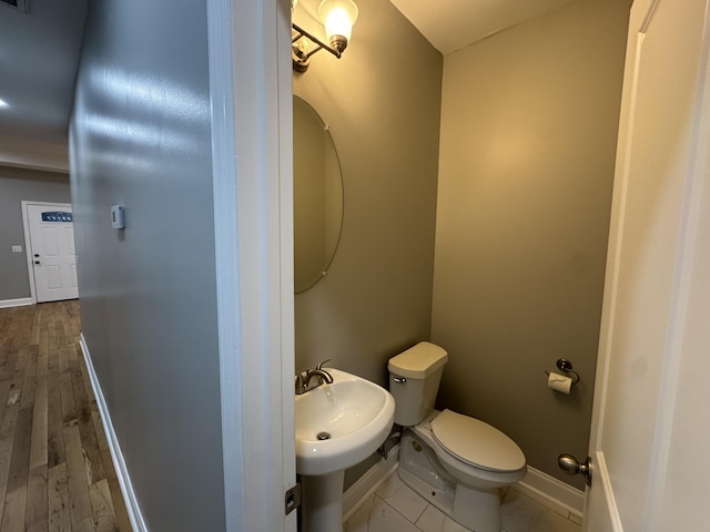 bathroom featuring hardwood / wood-style floors, toilet, and sink