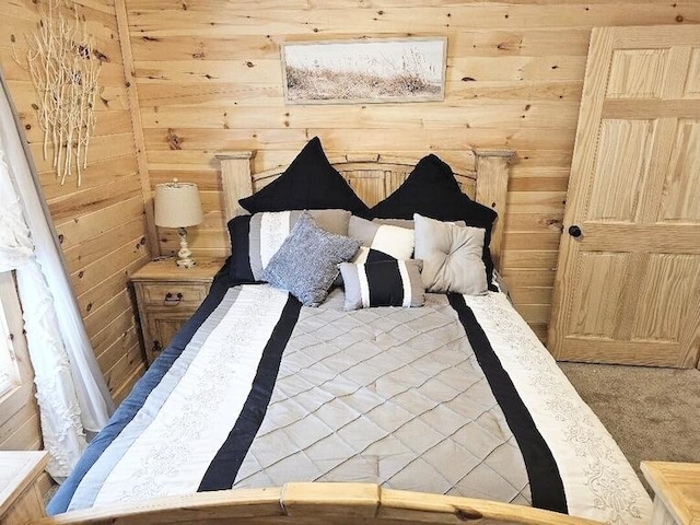 carpeted bedroom with wooden walls