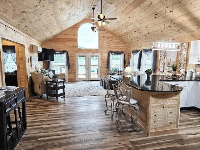 bar featuring wood walls, wooden ceiling, high vaulted ceiling, french doors, and white cabinets