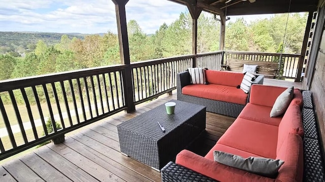 deck featuring an outdoor living space and ceiling fan