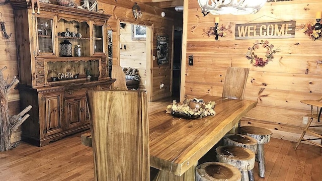 bar with wood walls and wood-type flooring