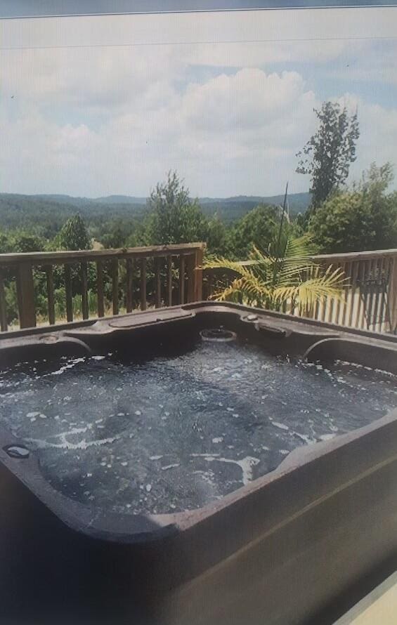 view of swimming pool with a hot tub