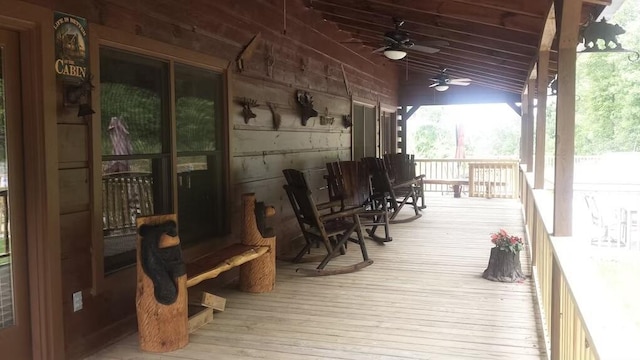 wooden terrace featuring ceiling fan and covered porch