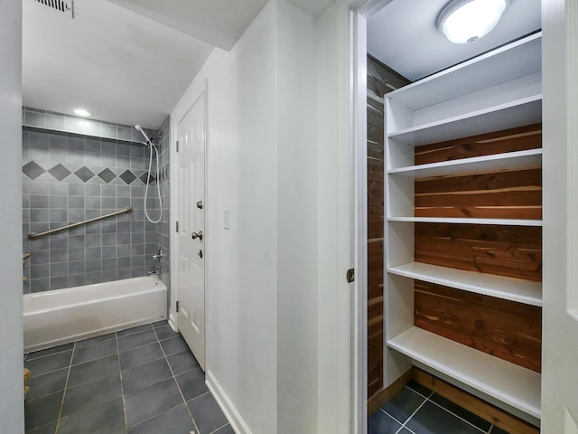 bathroom featuring tile patterned flooring and tiled shower / bath combo