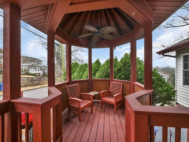 wooden deck with a gazebo and ceiling fan