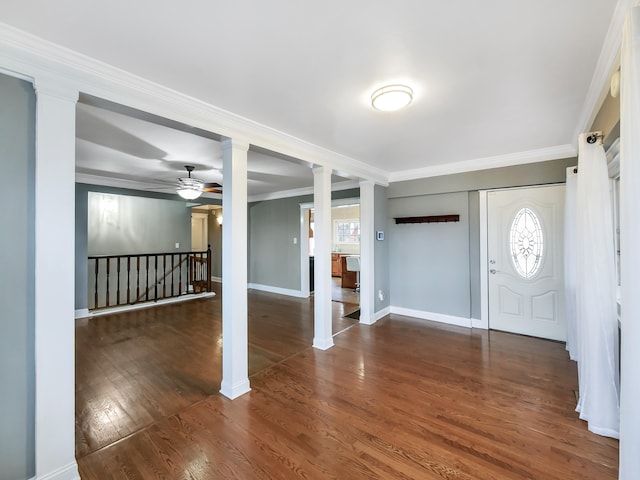 foyer entrance featuring a wealth of natural light, dark hardwood / wood-style flooring, ceiling fan, and ornamental molding