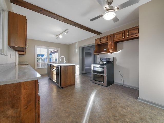 kitchen featuring sink, ceiling fan, an island with sink, appliances with stainless steel finishes, and beamed ceiling