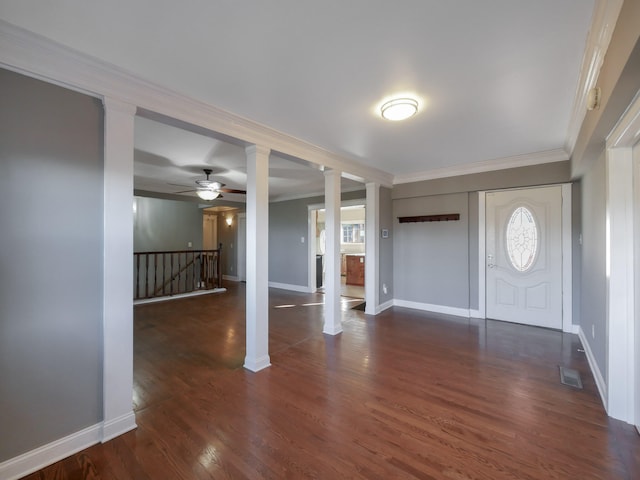 entrance foyer with dark hardwood / wood-style floors, a wealth of natural light, crown molding, and ceiling fan