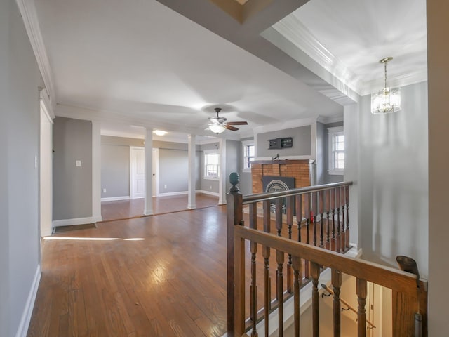 hall featuring a chandelier, hardwood / wood-style floors, and ornamental molding