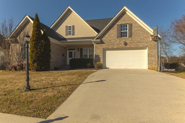 view of front of home with a garage and a front lawn