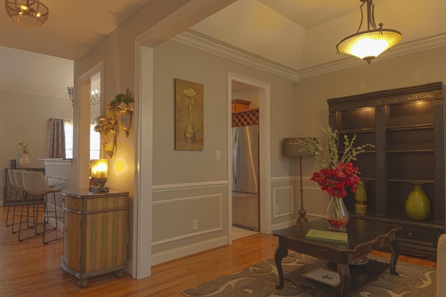 interior space with hardwood / wood-style floors and crown molding