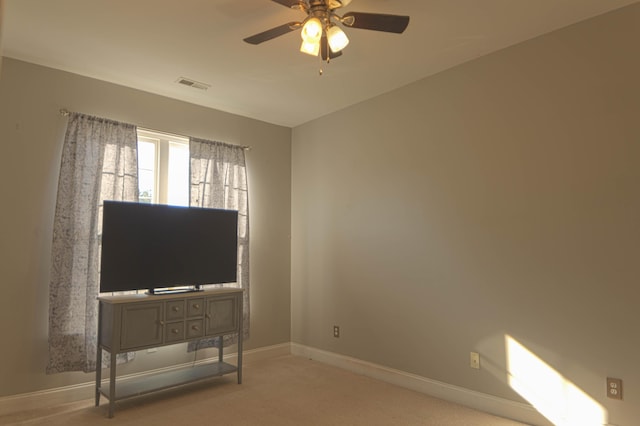 interior space with ceiling fan and light colored carpet