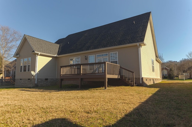 rear view of house with a lawn and a wooden deck