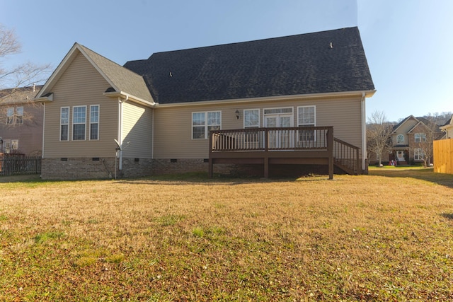 rear view of property featuring a deck and a lawn