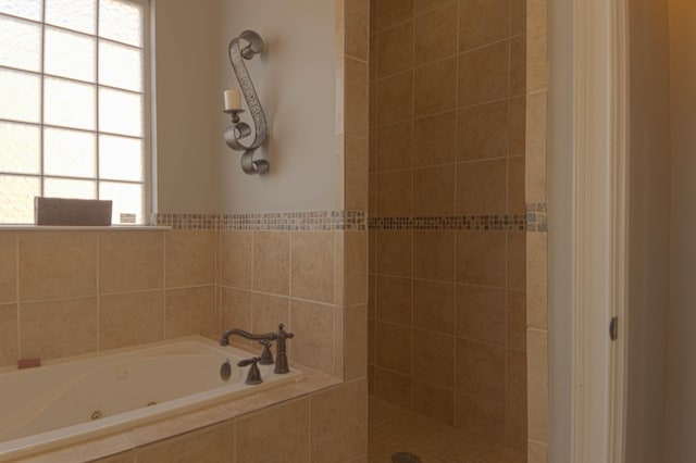 bathroom featuring shower with separate bathtub