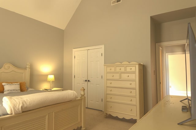 carpeted bedroom featuring lofted ceiling and a closet