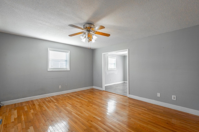 unfurnished room featuring ceiling fan, a textured ceiling, and light wood-type flooring