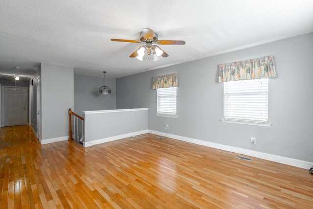 spare room with ceiling fan, hardwood / wood-style floors, and a textured ceiling