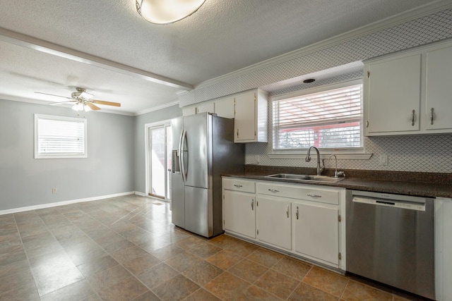 kitchen featuring white cabinets, sink, ceiling fan, a textured ceiling, and appliances with stainless steel finishes