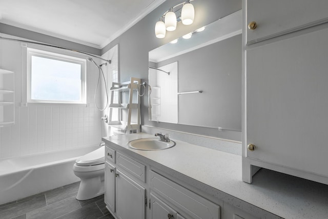 full bathroom with crown molding, vanity, tiled shower / bath combo, and toilet