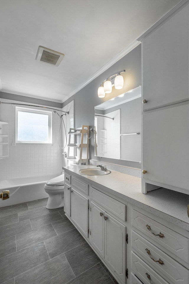 full bathroom featuring tiled shower / bath combo, toilet, crown molding, and vanity