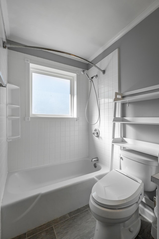 bathroom with crown molding, tiled shower / bath combo, and toilet