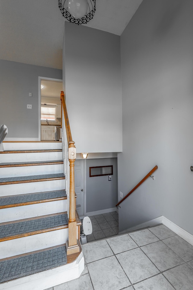 staircase featuring tile patterned floors