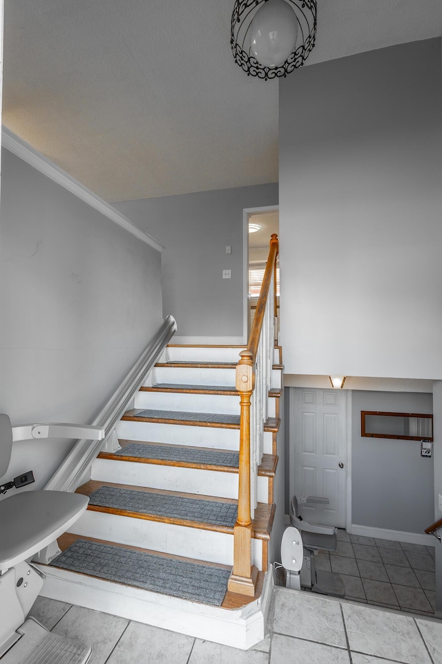 stairway featuring tile patterned floors