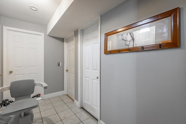 tiled home office featuring a textured ceiling