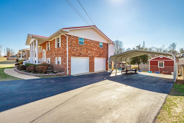 view of side of property featuring a shed, a garage, and a carport