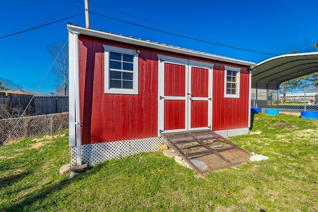 view of outdoor structure featuring a yard and a carport