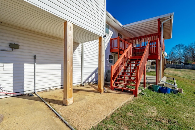 view of playground with a lawn, a patio, and a deck