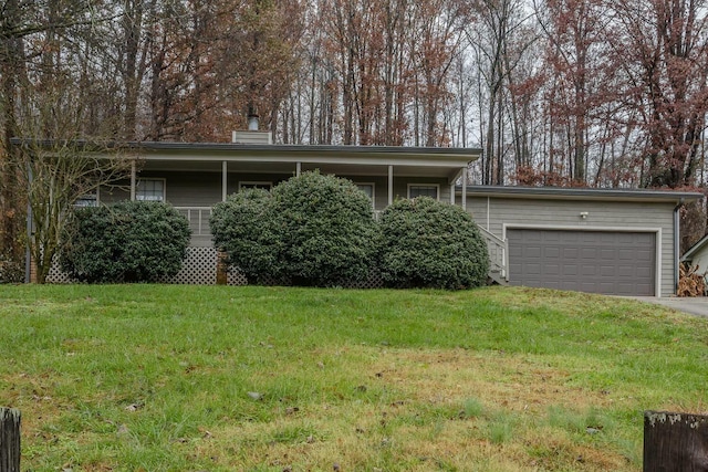 ranch-style house featuring a garage and a front lawn