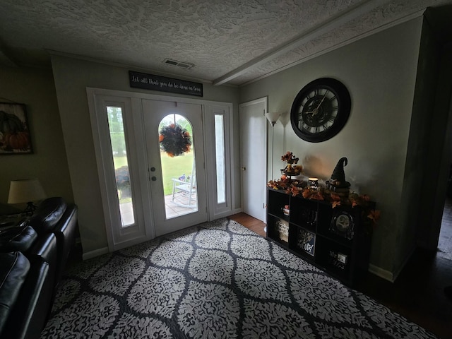 foyer entrance featuring a textured ceiling