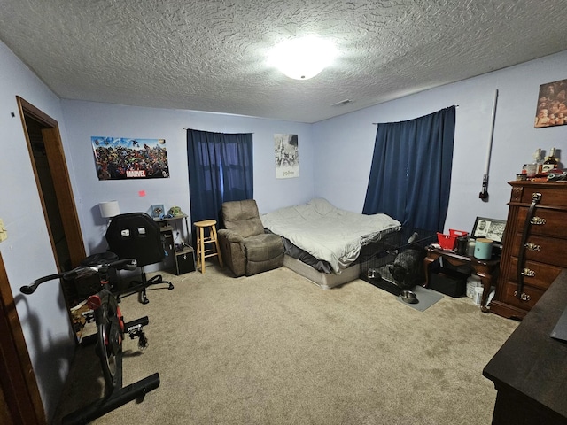 bedroom featuring carpet and a textured ceiling