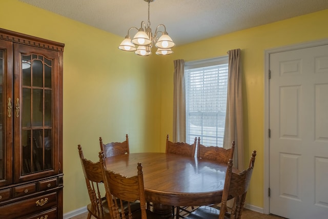 dining space with an inviting chandelier